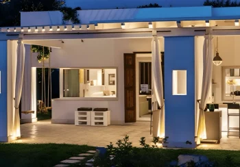 Exterior view of Villa Mia, a premier eco luxury villa in Salento featuring a natural pool, local stone architecture, and sustainable landscaping blending with the Mediterranean nature.