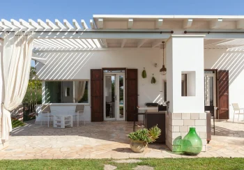 Ergonomic executive desk setup with a garden view inside Villa Mia, illustrating the high-tech standards of the best remote work villas Italy.