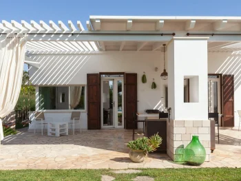 Ergonomic executive desk setup with a garden view inside Villa Mia, illustrating the high-tech standards of the best remote work villas Italy.